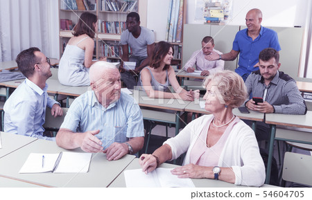 Mature man and woman talking during exam 54604705