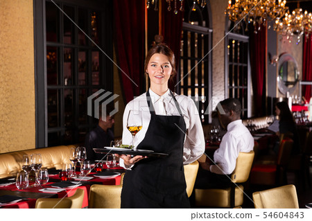 Portrait of female waiter who is holding tray with order Portrait of female waiter who is holding tray with order 54604843