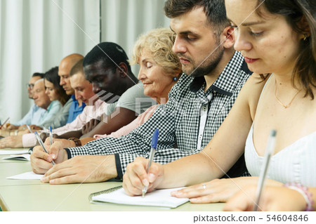 Group people listening and writing during course Group people listening and writing during course 54604846