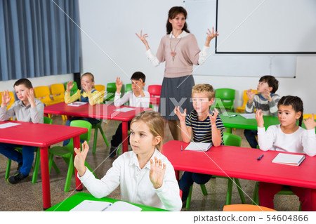 Children stretching with teacher Children stretching with teacher 54604866