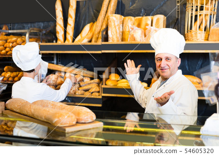 staff offering fresh baguettes 54605320