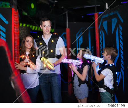 Kids and adults on lasertag arena Kids and adults on lasertag arena 54605499