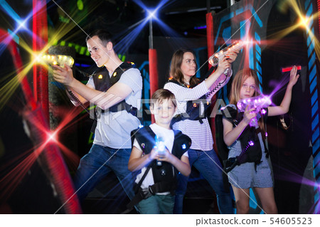 Parents and children playing laser tag in beams Parents and children playing laser tag in beams 54605523