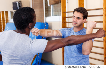 Two men practicing self defense techniques 54605619