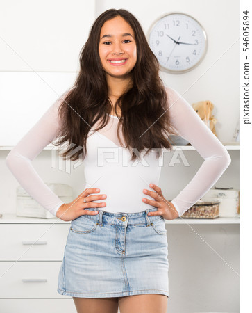 teenager girl standing and smiling at home teenager girl standing and smiling at home 54605894