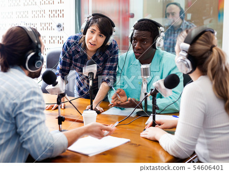 Scandal interview. Two outraged guests answering provocative questions of radio hosts during live radio show 54606401