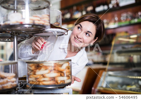 Woman choosing dessert Woman choosing dessert 54606495