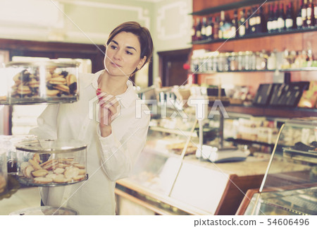 Woman choosing dessert Woman choosing dessert 54606496