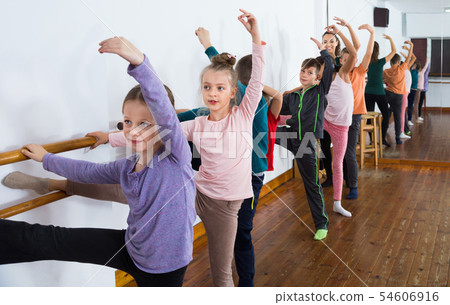 Young ballet dancers exercising in ballroom Young ballet dancers exercising in ballroom 54606916