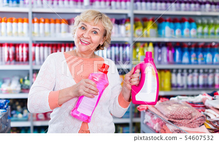 Woman consumer with household chemical products for washing indoors 54607532