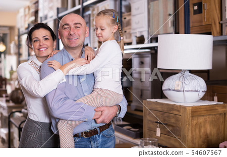 family in a large furniture store family in a large furniture store 54607567