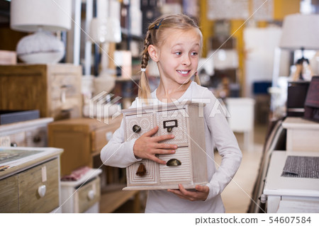 Smiling girl stading with design curbstone in store Smiling girl stading with design curbstone in store 54607584