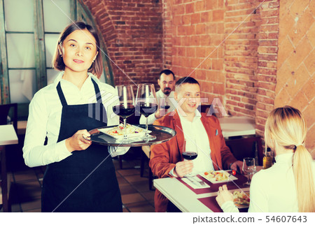 Happy female waiter showing country restaurant Happy female waiter showing country restaurant 54607643