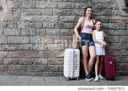 Tourists mother and daughter standing on stone wall 54607831