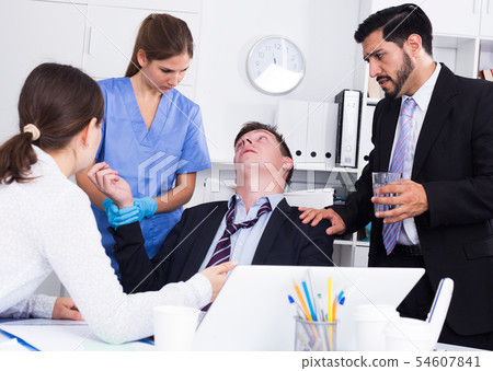 Man receiving first aid in office 54607841