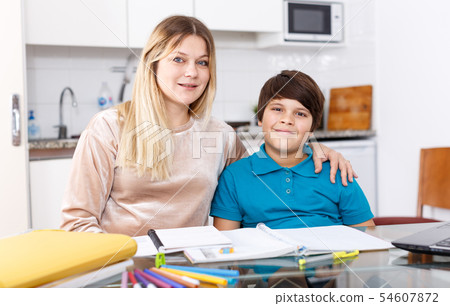 Family doing homework at kitchen 54607872