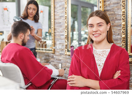 Young woman client sitting at chair in hairdressing salon Young woman client sitting at chair in hairdressing salon 54607969