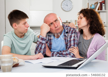 Family soothing chagrined man 54608132