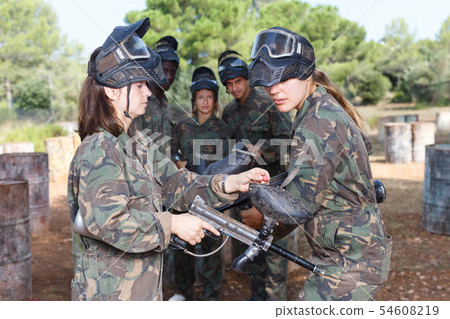 paintball player listening female instructor before game paintball player listening female instructor before game 54608219
