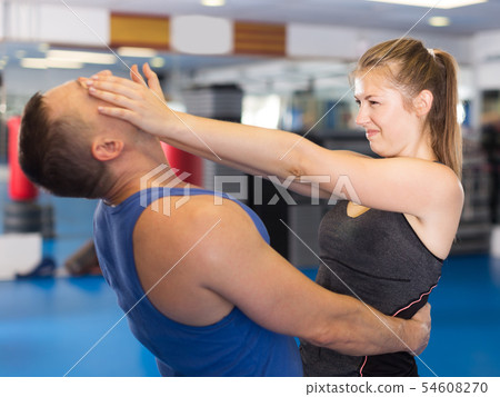 Cheerful woman is fighting with trainer Cheerful woman is fighting with trainer 54608270