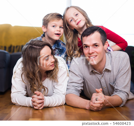 Smiling family enjoying evening together at home Smiling family enjoying evening together at home 54608423