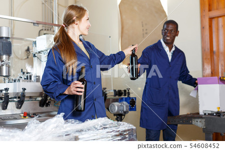 Two workers packing bottles at winery 54608452