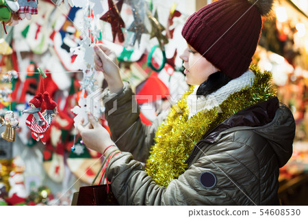 Young girl buying Christmas decoration 54608530