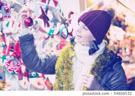 Smiling teen girl with Christmas decoration 54608532