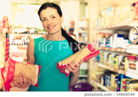 Female in the shop holding spaghetti Female in the shop holding spaghetti 54608540