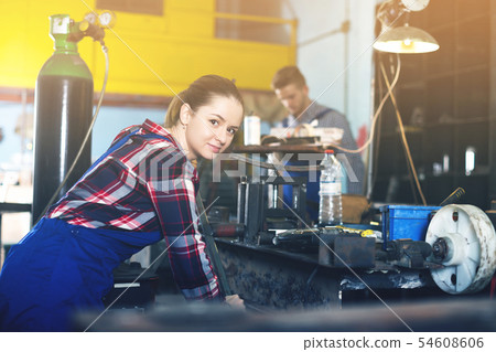 woman master is standing near vise equipment woman master is standing near vise equipment 54608606
