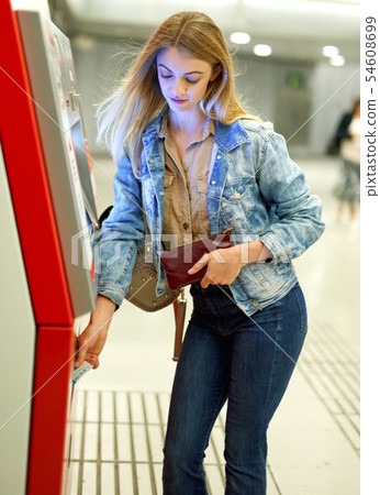 Girl traveler buys a ticket on the subway in the vending machine Girl traveler buys a ticket on the subway in the vending machine 54608699