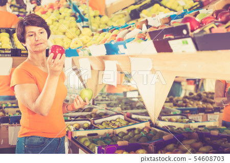 Adult woman is choosing colorful apples 54608703