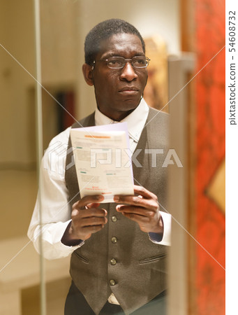 Man with guidebook at Art Museum Man with guidebook at Art Museum 54608732