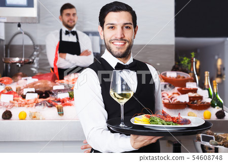 Waiter standing in fish restaurant 54608748