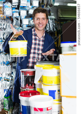 Worker selling tins of paint Worker selling tins of paint 54608857
