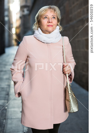 Female in the city in scarf and coat 54608859