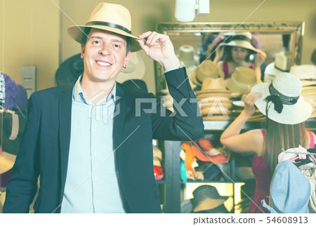 portrait of guy try on bucket hat at store portrait of guy try on bucket hat at store 54608913