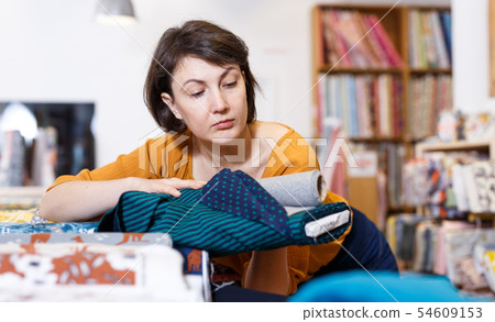 Woman looking for cloth in shop Woman looking for cloth in shop 54609153