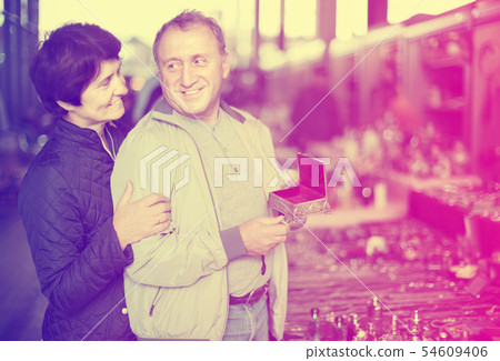 Loving senior family couple choosing vintage things Loving senior family couple choosing vintage things 54609406