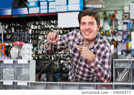 Portrait of employee which is selling and manufacturing keys 54609473