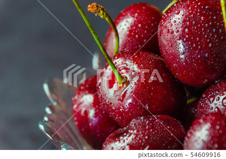 Close up of fresh cherry berries with water drops. 54609916