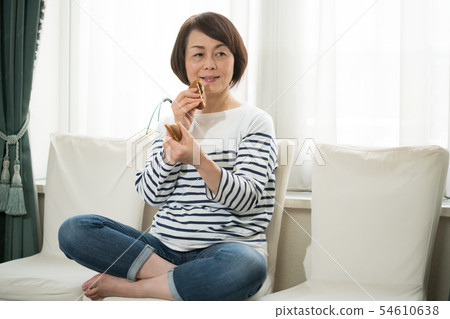 Woman eating confectionery 54610638