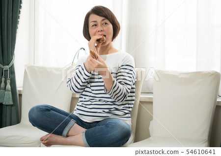 Woman eating confectionery 54610641