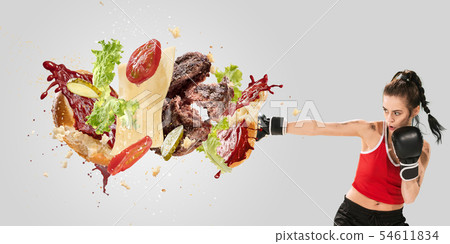 Burger's crashing by the boxer isolated on white background 54611834