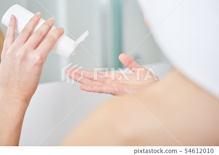 Beautiful Young Woman applying facial moisturizing Beautiful Young Woman applying facial moisturizing 54612010