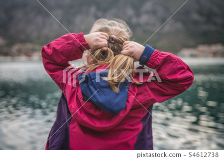 Girl adjusting her hair 54612738