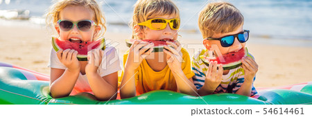 Children eat watermelon on the beach in sunglasses BANNER, LONG FORMAT 54614461