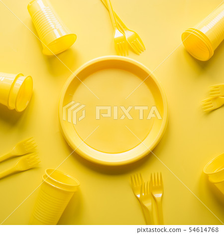 Singe use picnic utensils for recycling on yellow. 54614768