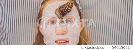 Young woman makes a face mask with snail mucus. Snail crawling on a face mask BANNER, LONG FORMAT Young woman makes a face mask with snail mucus. Snail crawling on a face mask BANNER, LONG FORMAT 54615091