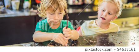Two children a boy and a girl make cookies from dough BANNER, LONG FORMAT Two children a boy and a girl make cookies from dough BANNER, LONG FORMAT 54615161